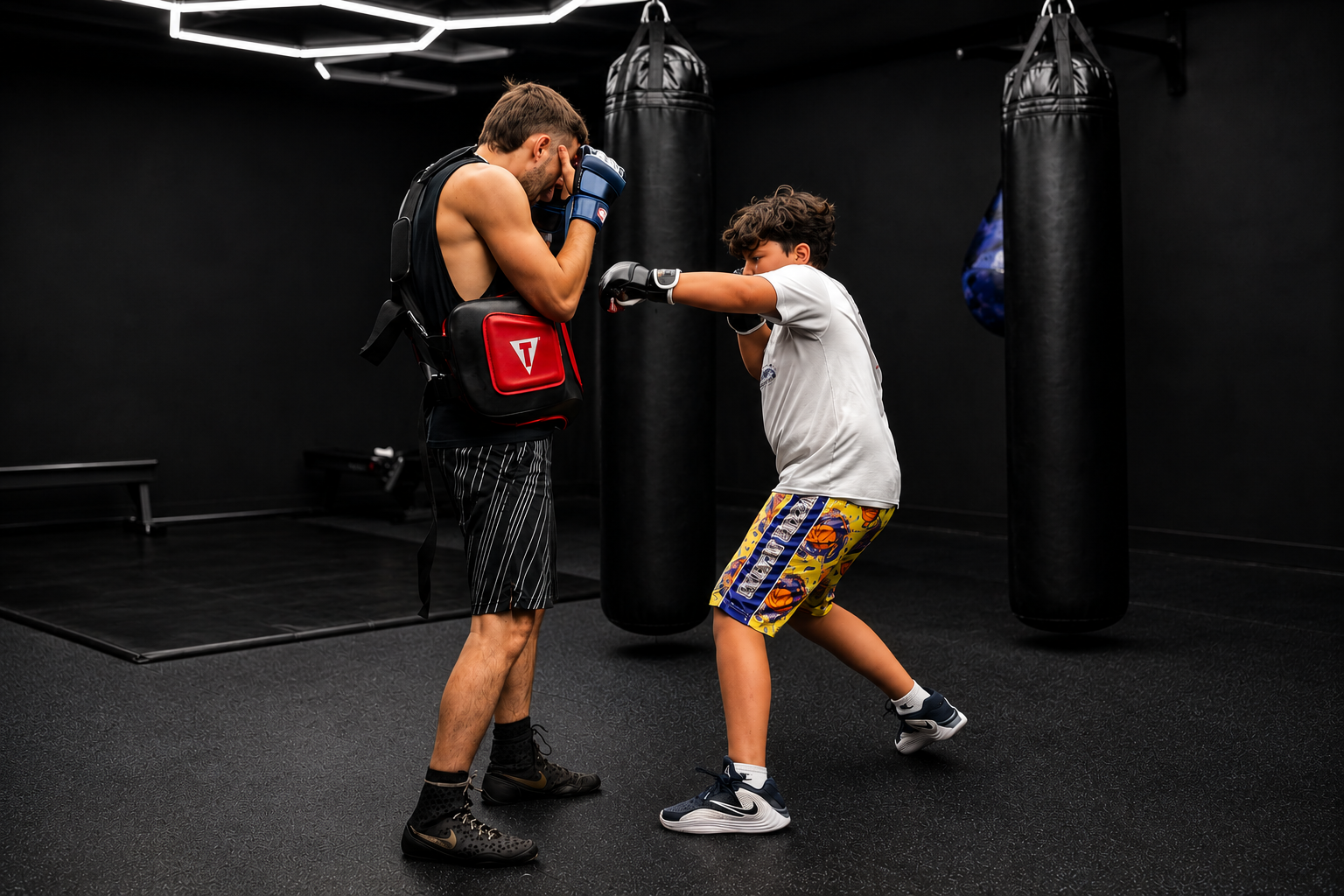 Young athlete working mitts with a coach at OG Boxing & Fitness